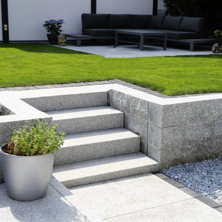 Neat and tidy garden with granite wall and solid block steps