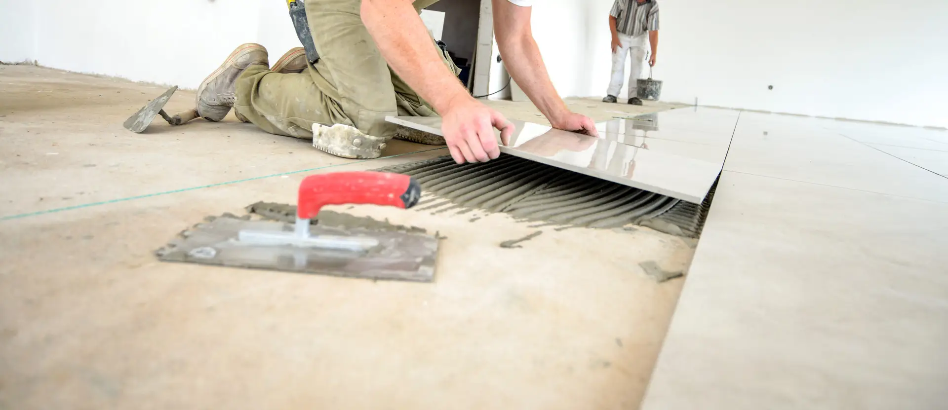 Professional skilled worker in work clothes, on the ground, selective focus, extreme little depth of field, lot of copy space, low angle view